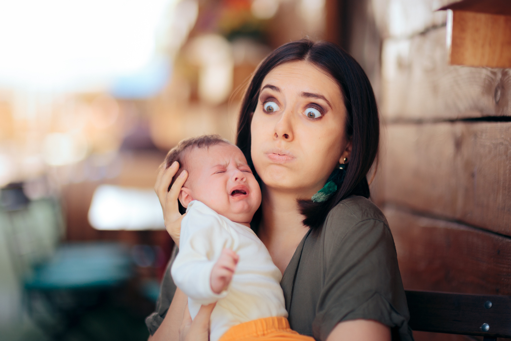 Stressed Mom Holding Crying Baby trying to Console Him